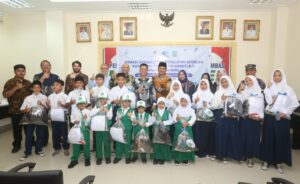 Foto bersama penyerahan bantuan kepada siswa-siswi secara simbolis