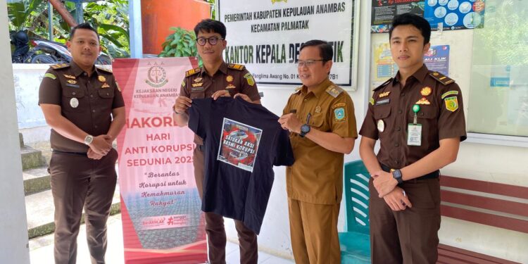 Penyerahan bagi bagi kaos di hari Anti Korupsi di desa putik oleh Kasintel Kejari Anambas