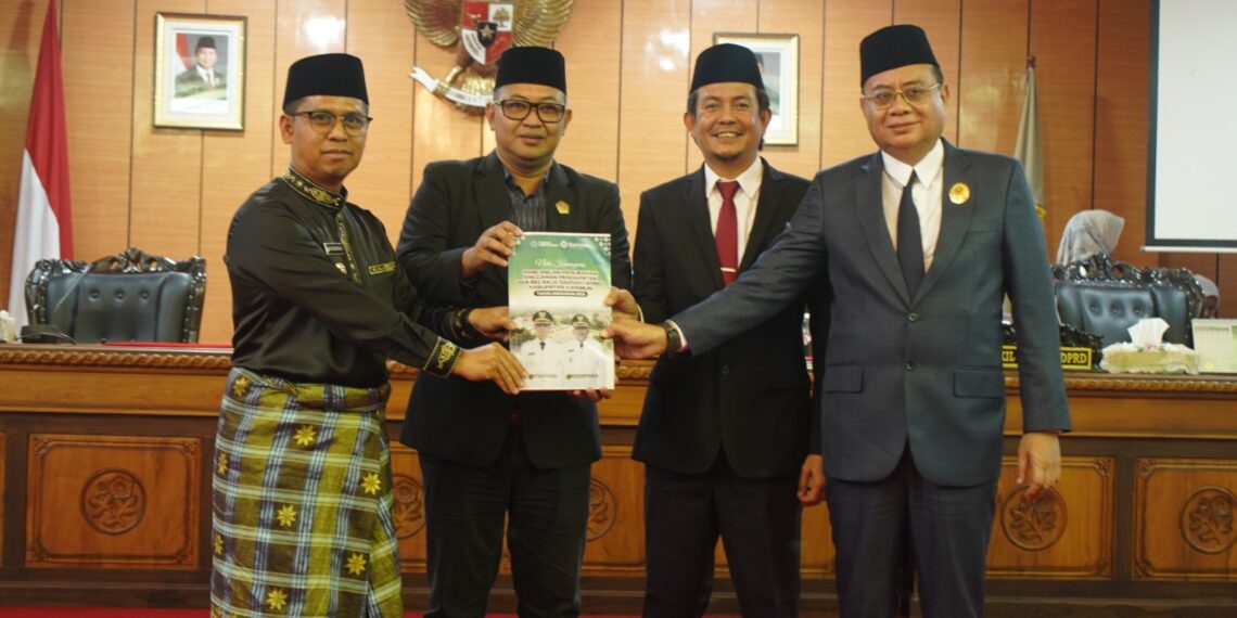 Bupati Karimun H. Iskandarsyah menyerahkan dokumen Ranperda P-APBD 2026 kepada pimpinan DPRD Karimun di Rapat Paripurna.